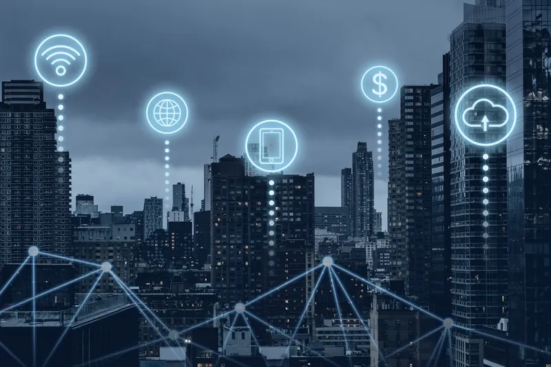 Une ville la nuit, reliée par un réseau de connexions : wifi, mobile, paiement et cloud.